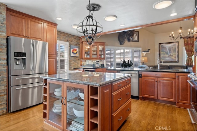 2645 S Patton Ave, San Pedro, CA 90731 - kitchen with brown cabinetry, a center island, a sink, a notable chandelier, and stainless steel appliances