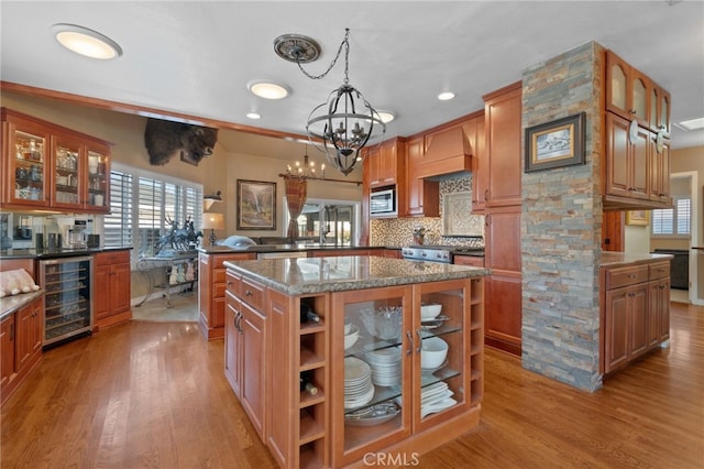 2645 S Patton Ave, San Pedro, CA 90731 - kitchen featuring glass insert cabinets, stainless steel microwave, light wood-type flooring, and beverage cooler