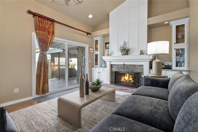2645 S Patton Ave, San Pedro, CA 90731 - living room featuring a notable chandelier, a fireplace, recessed lighting, baseboards, and lofted ceiling