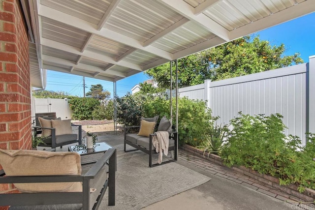view of patio with an outdoor living space and a fenced backyard