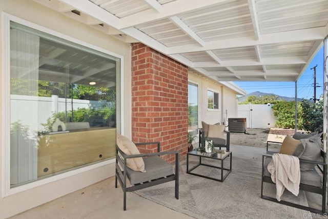 view of patio / terrace with cooling unit and fence