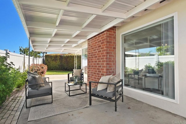 view of patio with outdoor lounge area and fence
