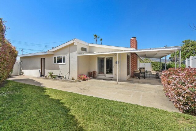 6065 Zora St, La Mesa, CA 91942 - rear view of house with a chimney, stucco siding, and a patio area