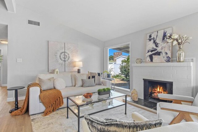 6065 Zora St, La Mesa, CA 91942 - living room with wood finished floors, lofted ceiling, a fireplace, and baseboards