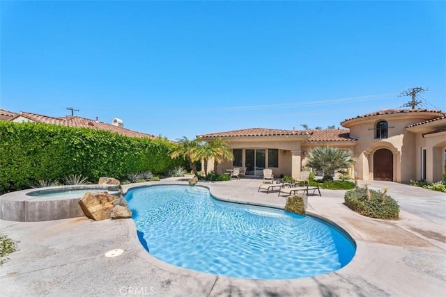 view of pool featuring a patio area and a pool with connected hot tub