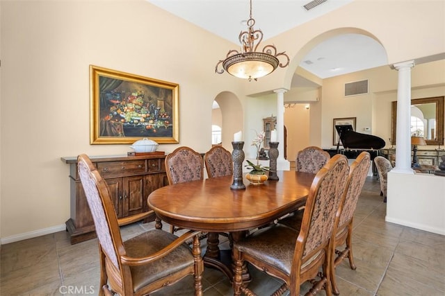 tiled dining room with plenty of natural light, ornate columns, visible vents, arched walkways, and baseboards