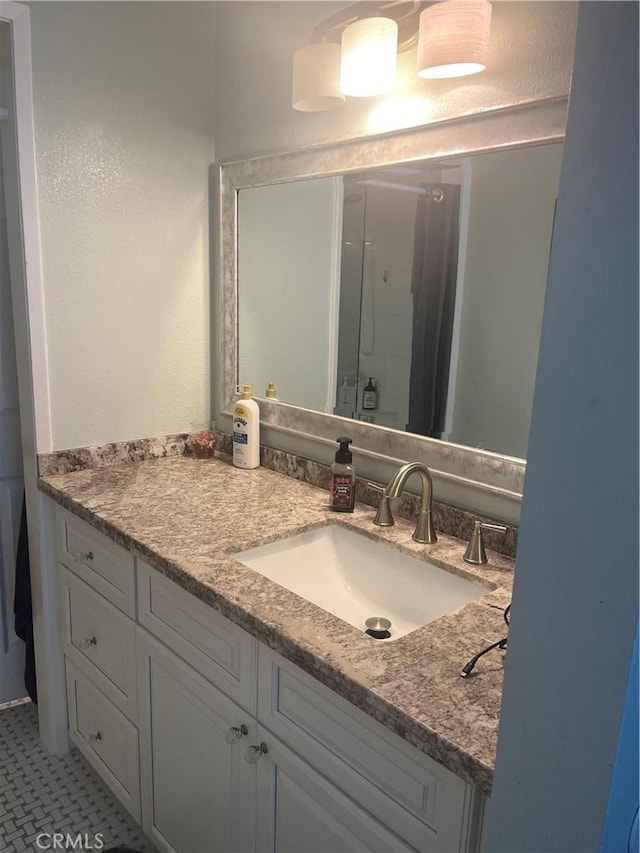 full bath with a stall shower and vanity