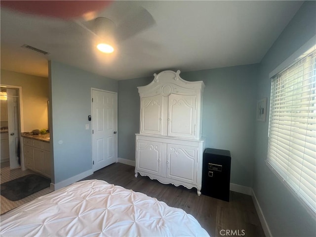 bedroom with dark wood-style flooring, baseboards, and visible vents