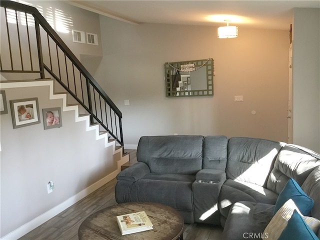 living room with visible vents, stairway, wood finished floors, and baseboards
