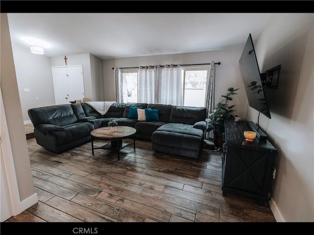 living room featuring hardwood / wood-style flooring and baseboards