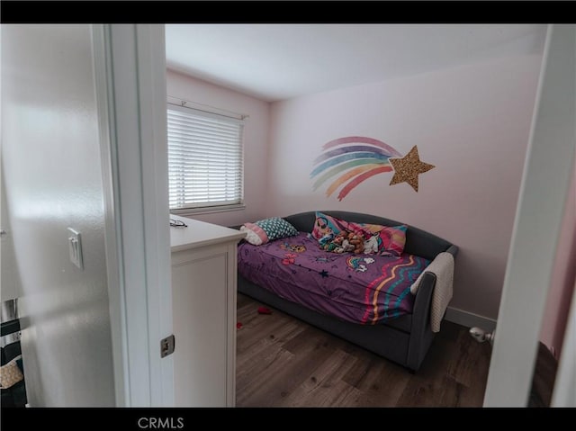bedroom featuring wood finished floors