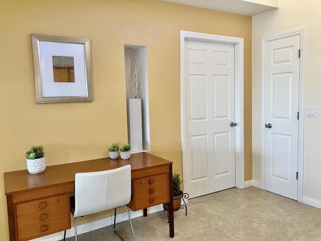 office area featuring baseboards and light tile patterned floors