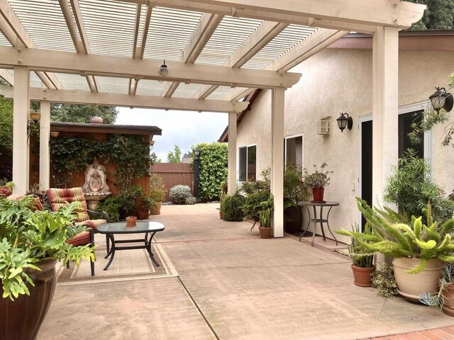 view of patio / terrace featuring fence and a pergola