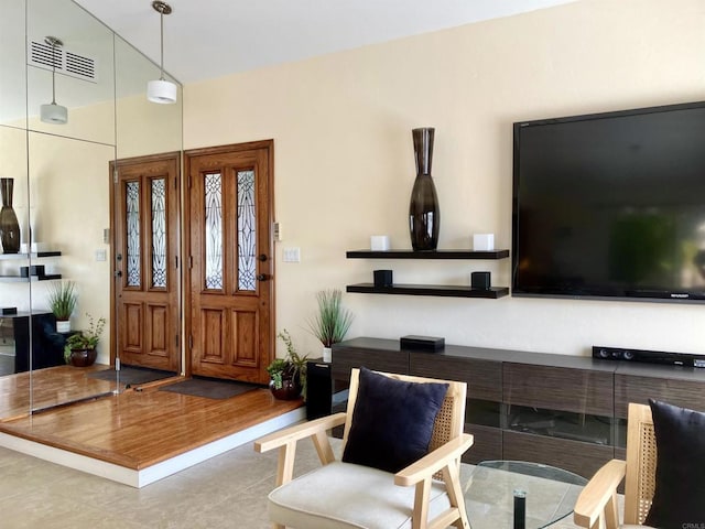 foyer entrance with visible vents and tile patterned floors