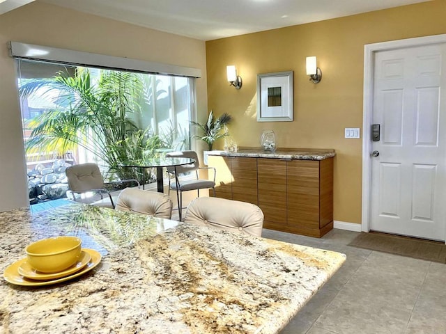 interior space featuring baseboards and light tile patterned floors