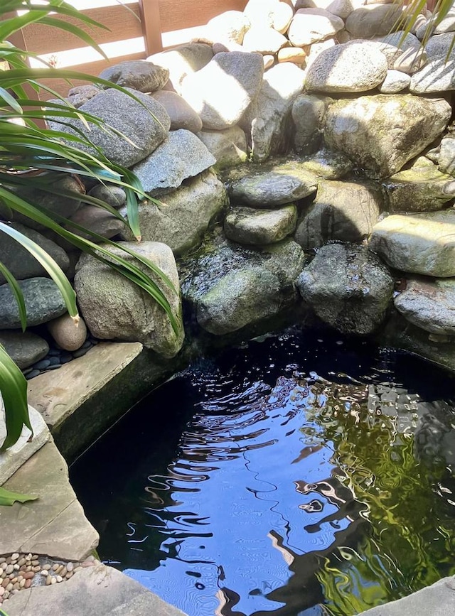 exterior details featuring a garden pond