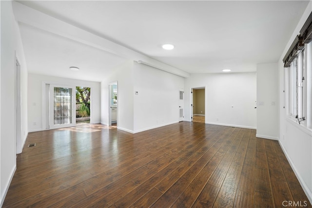 unfurnished living room with dark wood-type flooring, visible vents, baseboards, and recessed lighting