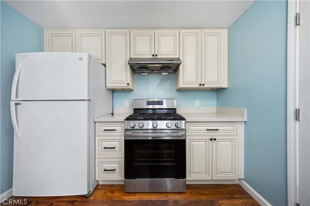 kitchen with light countertops, stainless steel gas range, freestanding refrigerator, and under cabinet range hood