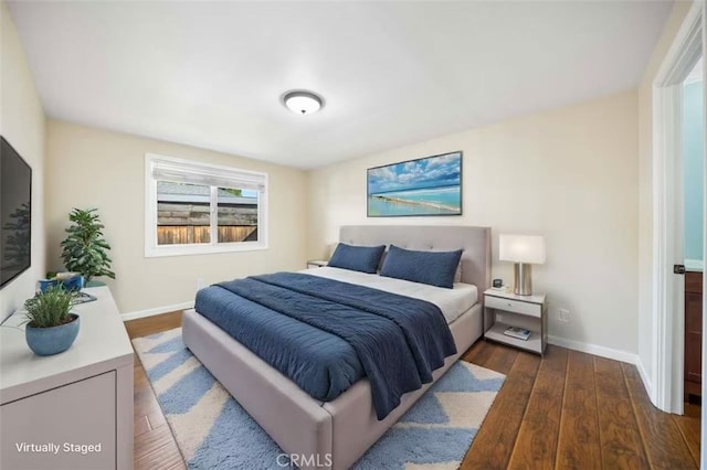 bedroom featuring dark wood-type flooring and baseboards