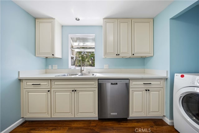 clothes washing area with washer / clothes dryer, a sink, and dark wood finished floors