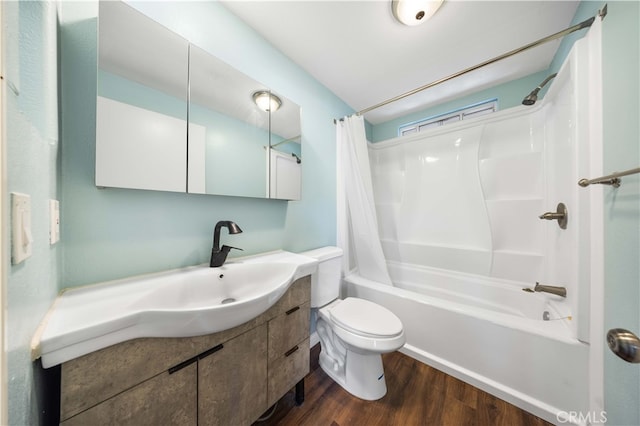 bathroom featuring toilet, vanity, wood finished floors, and shower / bath combination with curtain