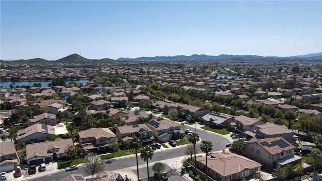 birds eye view of property featuring a water and mountain view and a residential view