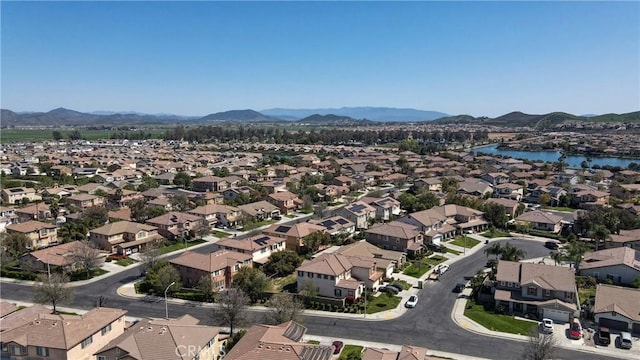 bird's eye view with a water and mountain view and a residential view