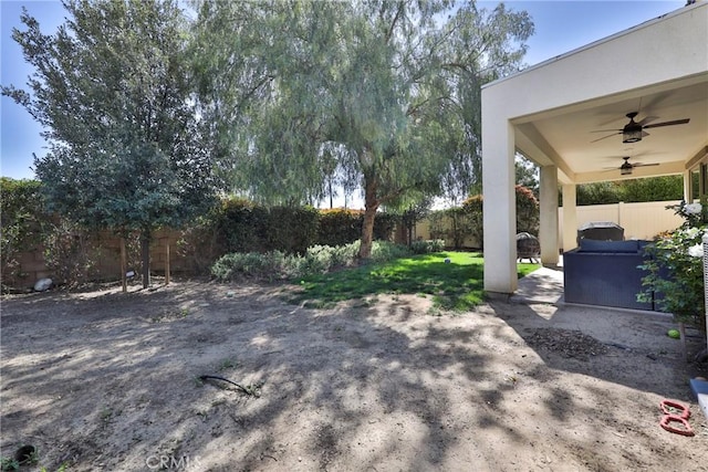 view of yard featuring a patio, a fenced backyard, and a ceiling fan