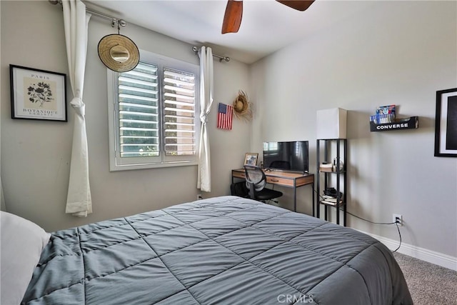 carpeted bedroom featuring ceiling fan and baseboards