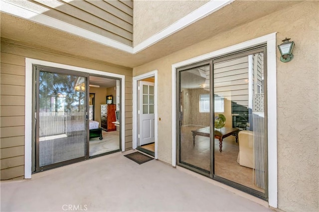 property entrance featuring a patio area and stucco siding