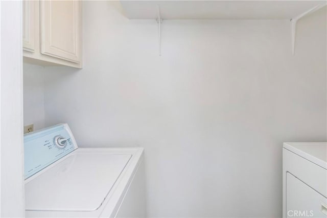 washroom with independent washer and dryer and cabinet space