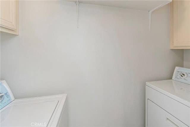 laundry area with washer and dryer and cabinet space