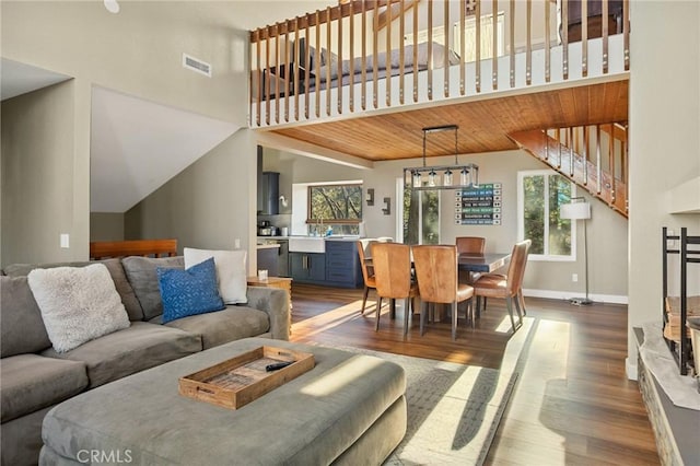 living area featuring visible vents, a wealth of natural light, and dark wood finished floors