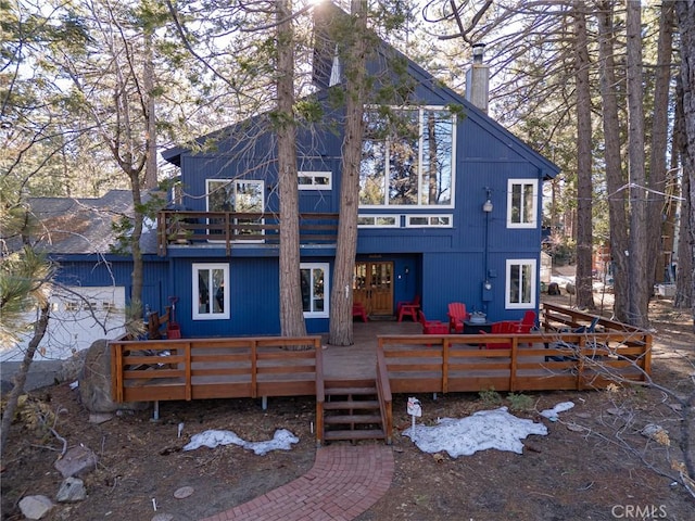 view of front facade featuring a deck and a chimney