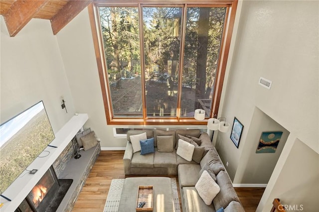 interior space featuring wood finished floors, baseboards, visible vents, and plenty of natural light