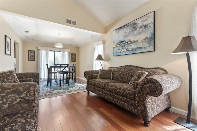 22690 Mountain View Rd, Moreno Valley, CA 92557 - living room with visible vents, baseboards, lofted ceiling, and wood finished floors