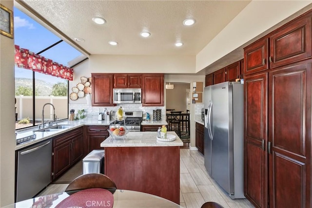 22690 Mountain View Rd, Moreno Valley, CA 92557 - kitchen featuring decorative backsplash, a kitchen island, appliances with stainless steel finishes, dark brown cabinets, and a sink
