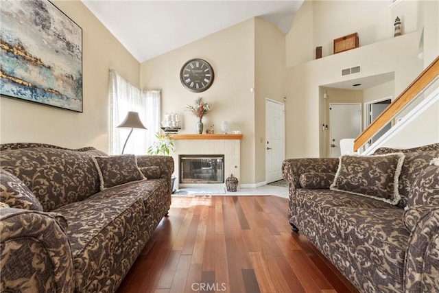 22690 Mountain View Rd, Moreno Valley, CA 92557 - living room featuring high vaulted ceiling, a fireplace, wood finished floors, and visible vents