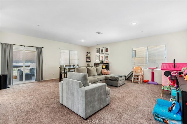 carpeted living room featuring recessed lighting and visible vents