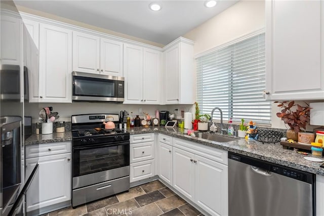 kitchen with a sink, white cabinets, recessed lighting, and stainless steel appliances