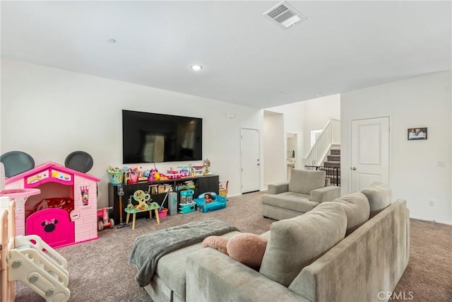 carpeted living area featuring visible vents and stairs