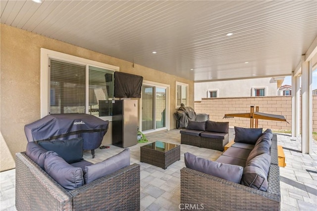 view of patio / terrace with an outdoor living space and fence