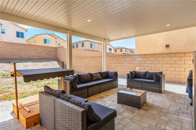 view of patio featuring an outdoor living space and a fenced backyard