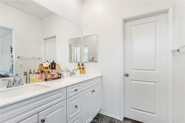 bathroom featuring double vanity, a sink, and baseboards