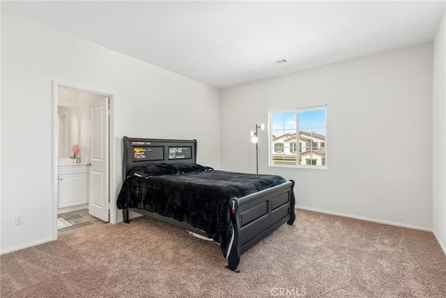 bedroom with visible vents, baseboards, carpet flooring, and connected bathroom