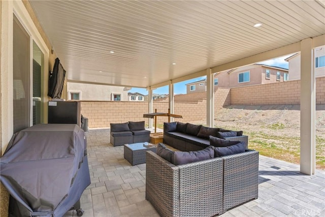 view of patio featuring grilling area, outdoor lounge area, and a fenced backyard