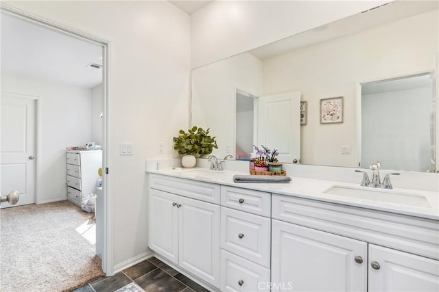 bathroom with a sink, visible vents, and double vanity