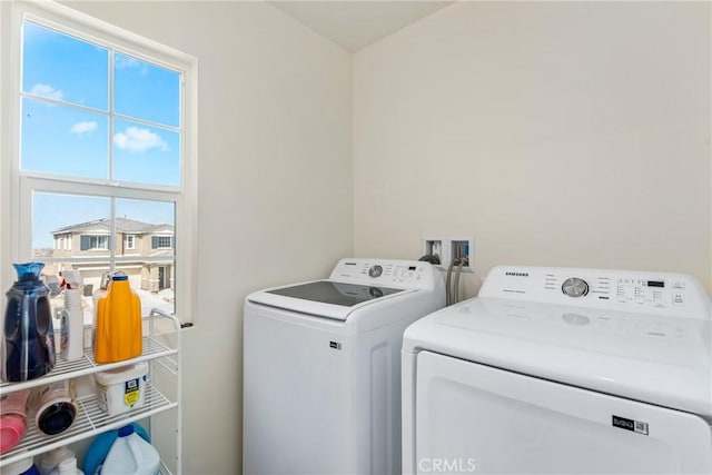 clothes washing area with laundry area and washing machine and clothes dryer