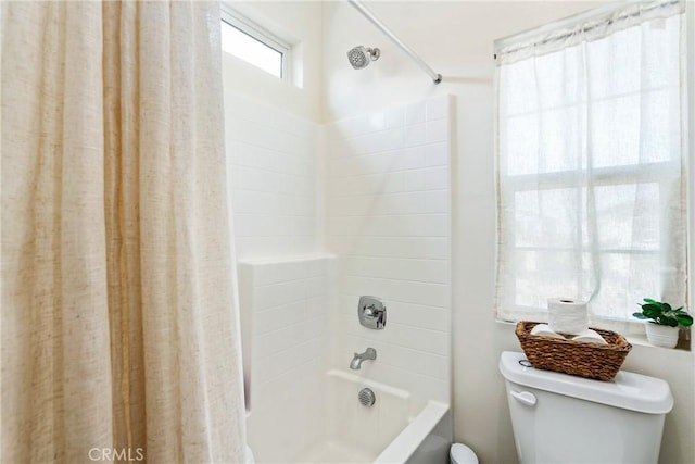 bathroom featuring shower / bathtub combination with curtain and toilet