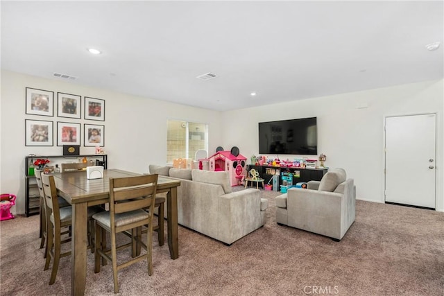 carpeted living area featuring recessed lighting and visible vents
